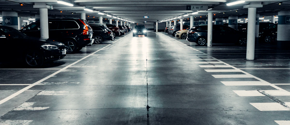 Residential parking garage under a Brooklyn co-op, typical of a late Local Law 126 filing case