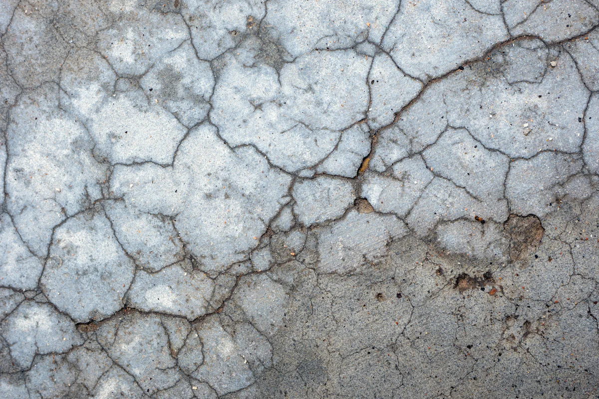 Cracked and deteriorated garage concrete before repair in Brooklyn