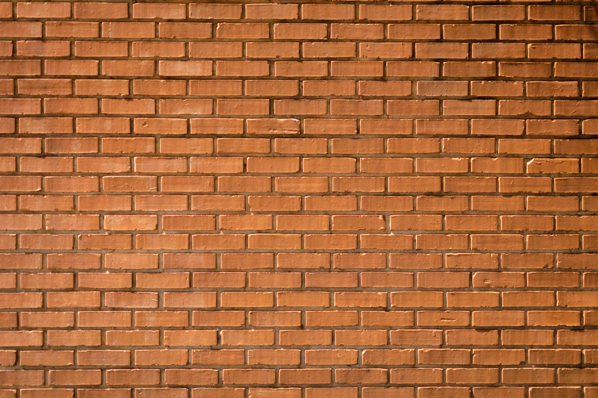 Close-up of weathered brick and worn mortar joints, the kind of wear found on older Brooklyn parapets
